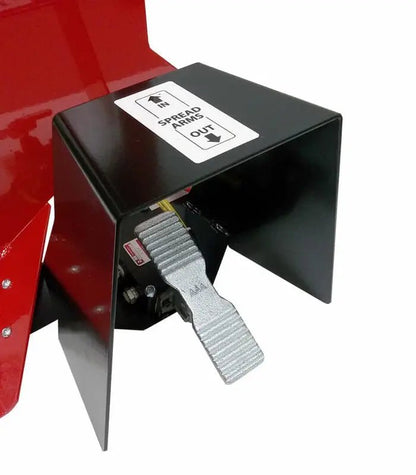 Branick 5130 tire spreader close-up showing silver metal foot pedal and black guard housing used to control pneumatic tire spreading operation for hands-free service.