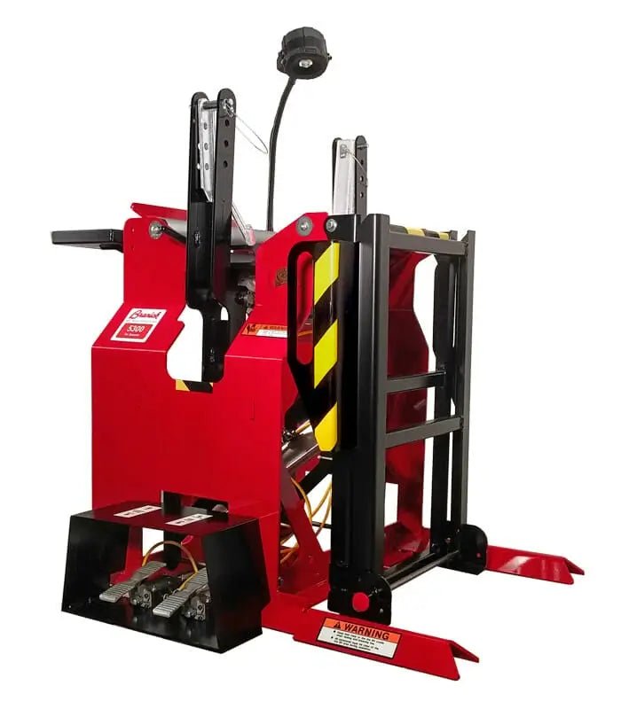 Branick 5300 tire spreader, side angled view of heavy-duty super single model featuring pneumatic arms, safety-striped guards, and overhead work light for large truck and OTR tire maintenance.