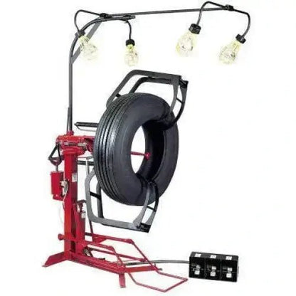 Branick 900-102 EF air-powered full circle truck tire spreader shown with mounted tire and overhead inspection lights, providing full visibility for tire repair and recapping operations.