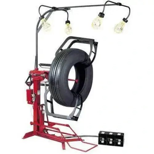 Branick 900-102 EF air-powered full circle truck tire spreader shown with mounted tire and overhead inspection lights, providing full visibility for tire repair and recapping operations.
