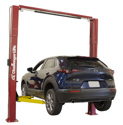 Challenger VLE10 two post lift shown lifting a Mazda CX-30 SUV, featuring red posts and yellow Versymmetric arms for efficient service bay vehicle access