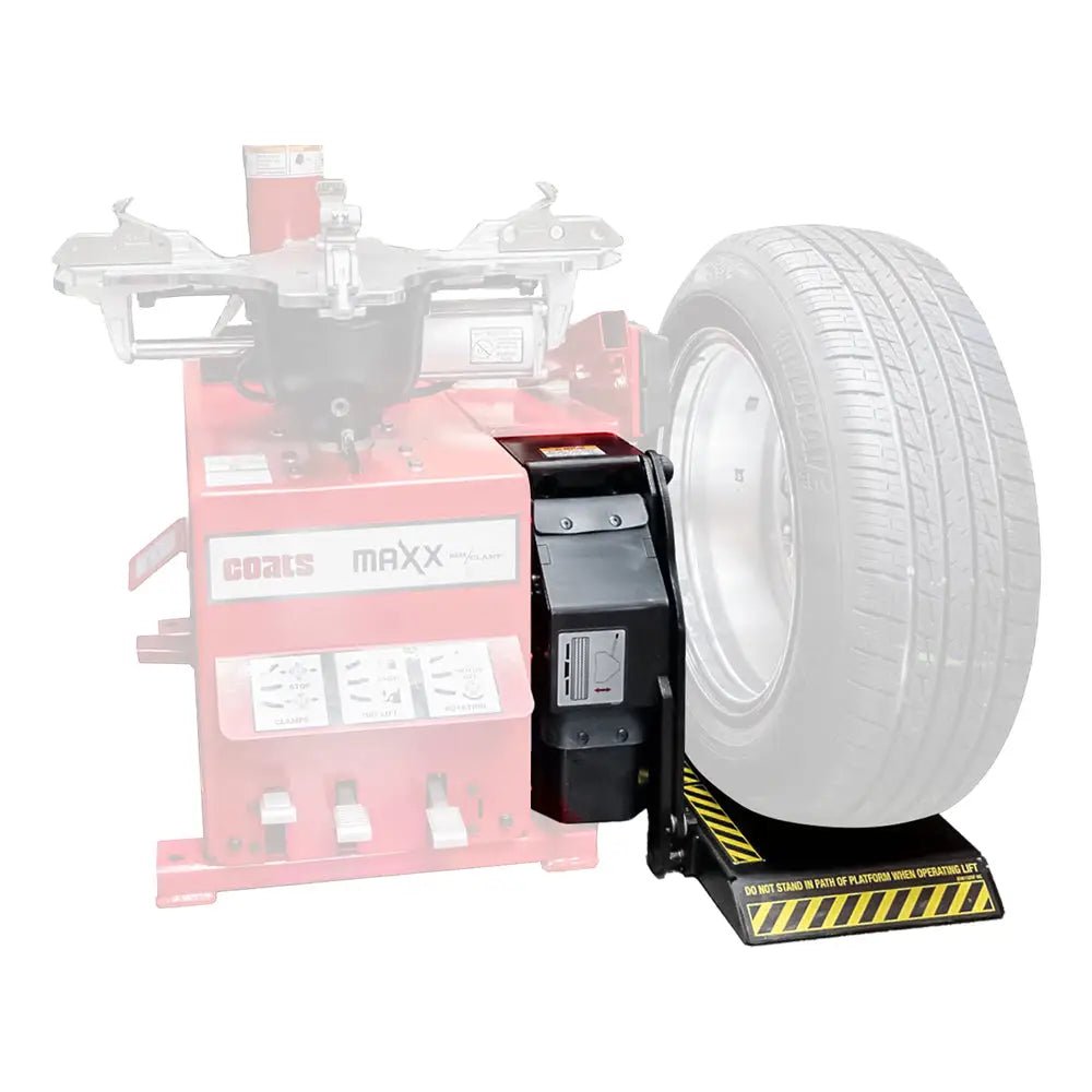 Tire balancing machine attachment with a mounted car wheel