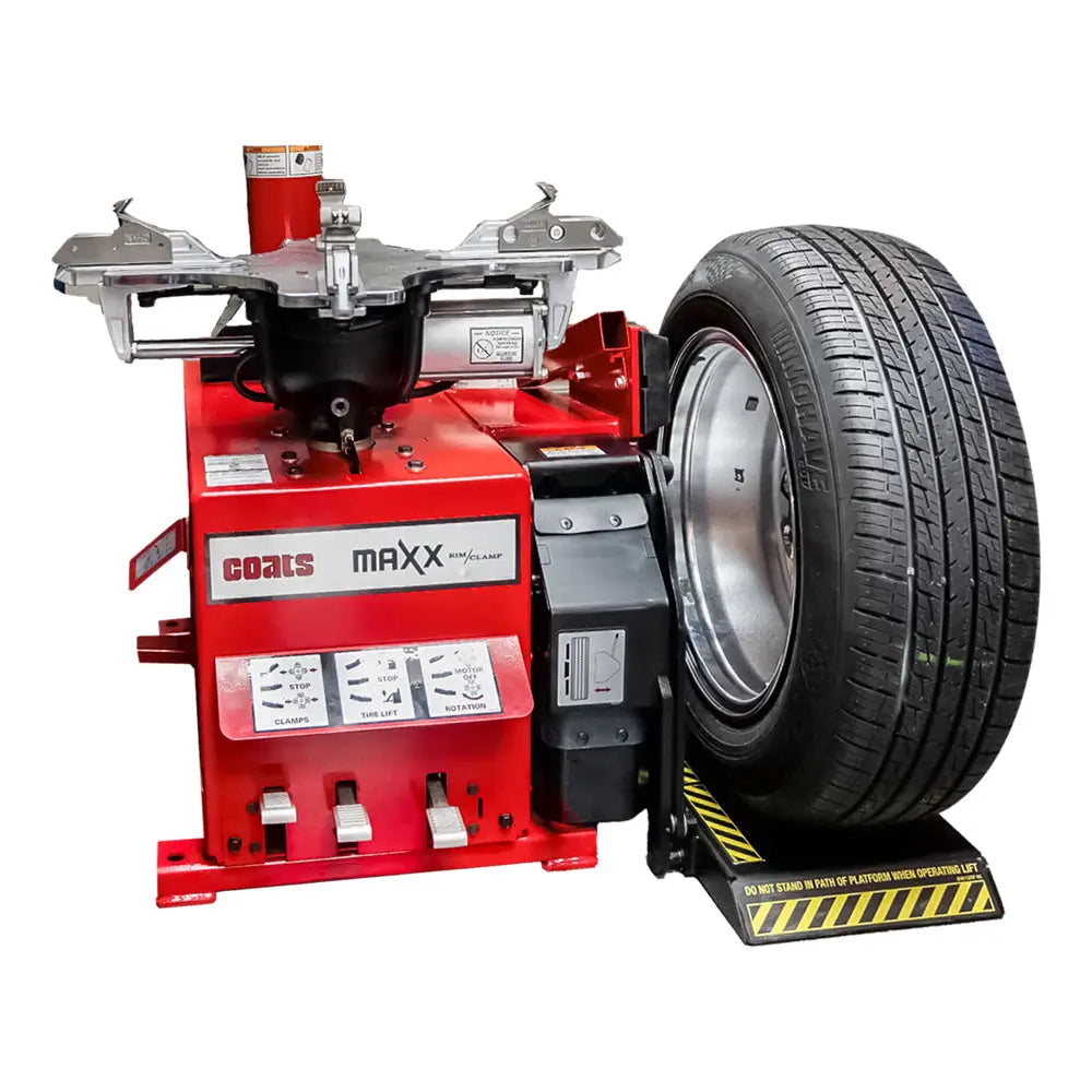 Tire mounting on a wheel balancing machine with a safety guard.