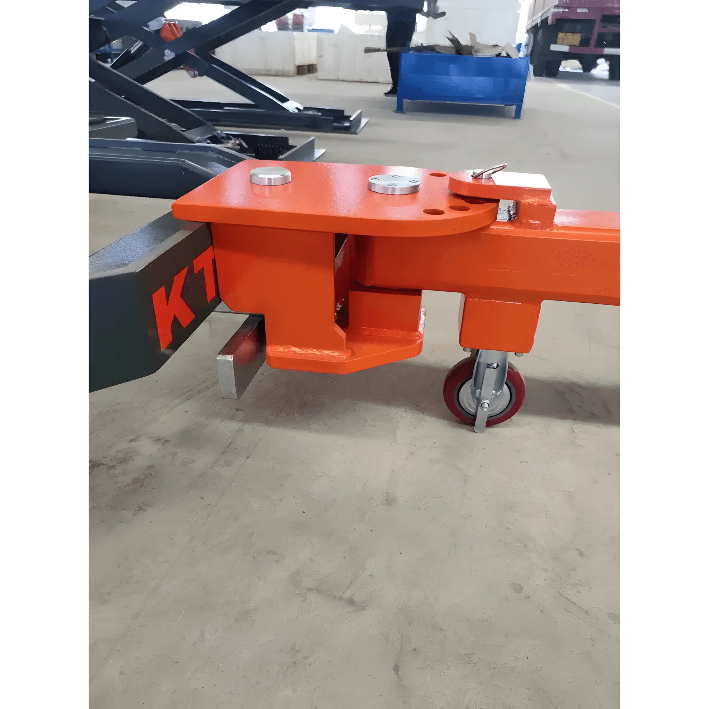 Katool KT-310 auto body frame machine close-up of the base with orange mounting assembly and caster wheel, showing support connection on concrete floor.