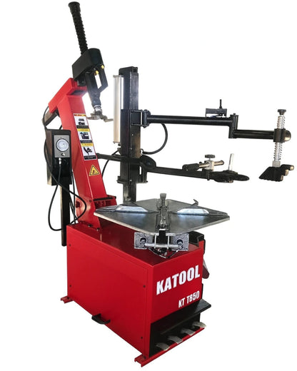 Katool KT-T850 tire changer tilt-arm machine shown from angled side view with wheel clamp, bead breaker arm, and foot pedal controls visible