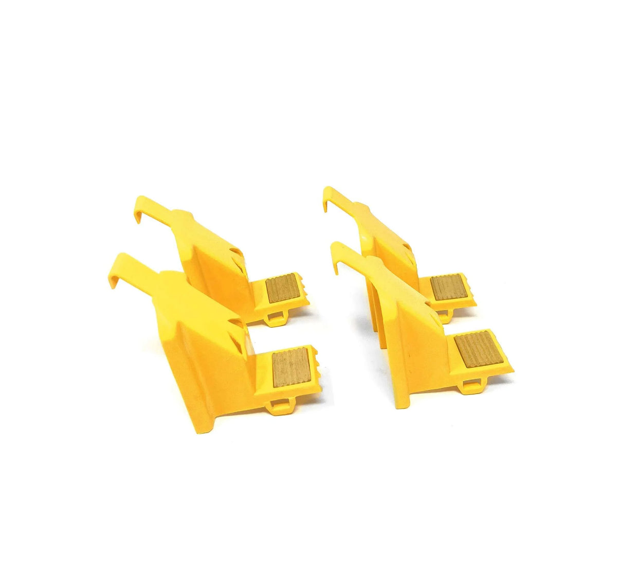 Four yellow plastic outside jaw covers arranged in two pairs, viewed at an angle.